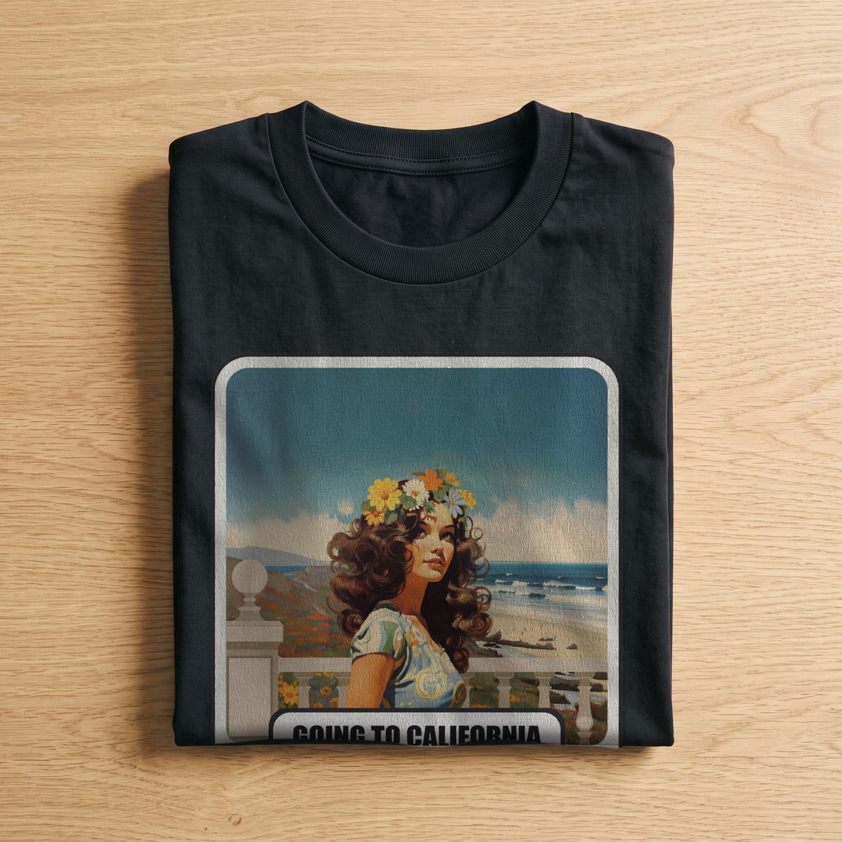 La t-shirt nera «Going to California – London, 1971» piegata su un piano di legno, come arriva a casa (ricostruzione al computer)